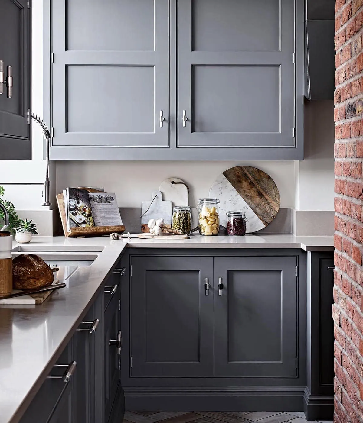 Modern grey kitchen cabinetry with sleek matte finish and stainless steel hardware.