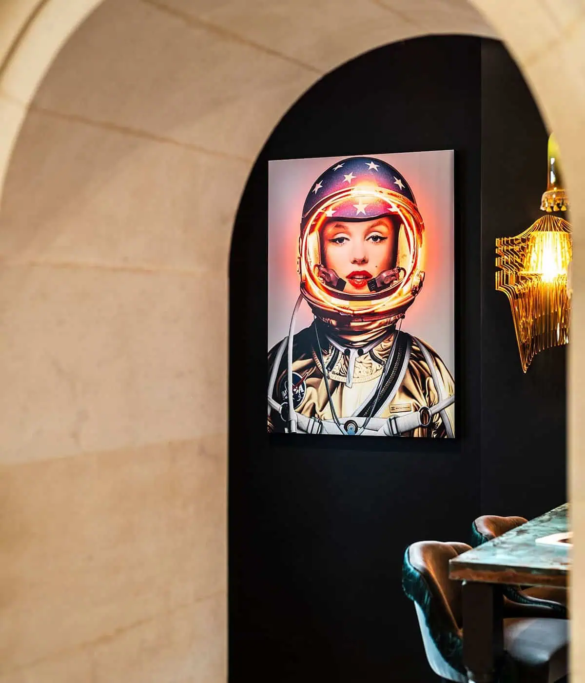 Vibrant astronaut portrait on wall in stylish, contemporary interior design by Furnish Studio.